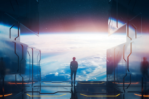 Casual man standing on space platform watching planet Earth