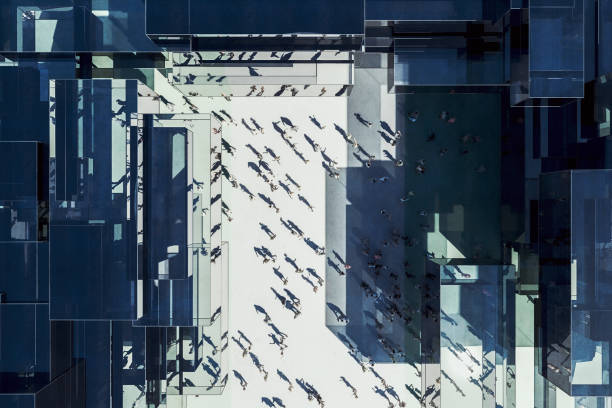 Modern glass office building with business people from above Modern glass office building with business people from above. 3D generated image. drone point of view road stock pictures, royalty-free photos & images