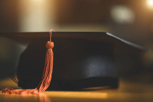 istock black graduation cap placed on a wooden table 1321600397