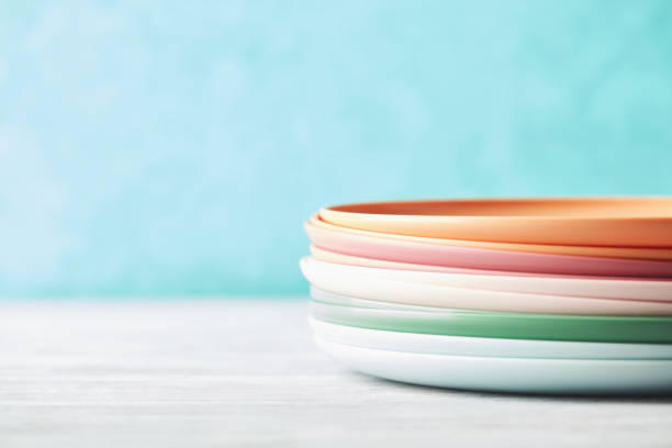 istock Stack of reusable colorful plastic dishes against bright blue background 1321601378