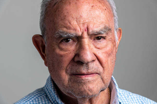 istock Serious hispanic senior man front mugshot 1321601894