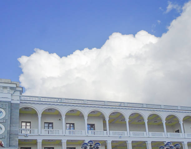 istock White clouds against blue sky above gallery with colonnade, selective focus 1321602871