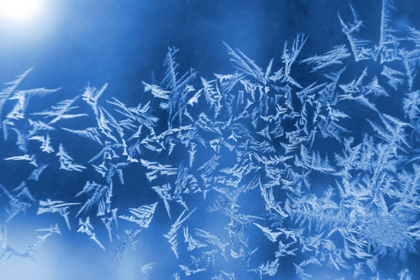 istock frosty patterns on the window glass closeup. natural textures and backgrounds. ice patterns on frozen 1321605224