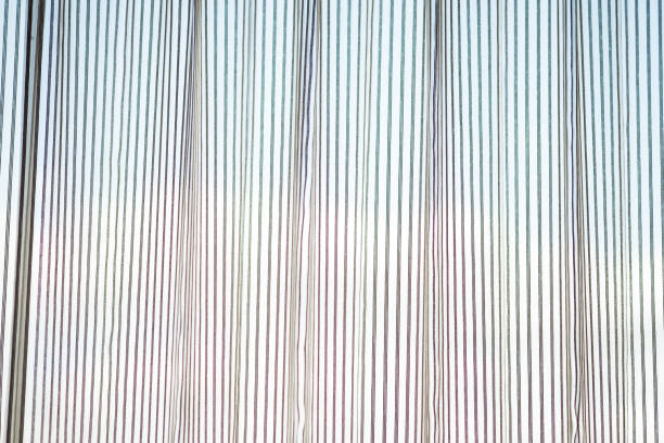 istock White transparent window curtains with sun shining 1321609989