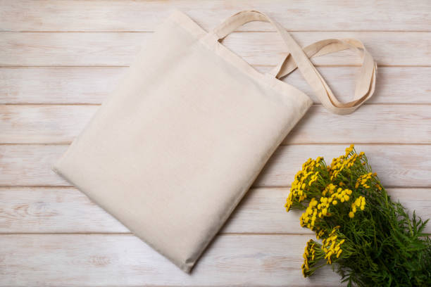 istock Rustic tote bag mockup with yellow wildflowers 1321612615