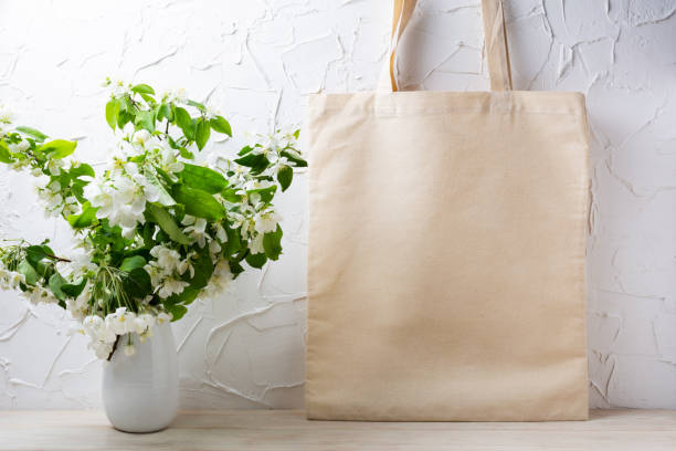 istock Rustic tote bag mockup with  flowering apple tree branch 1321612627