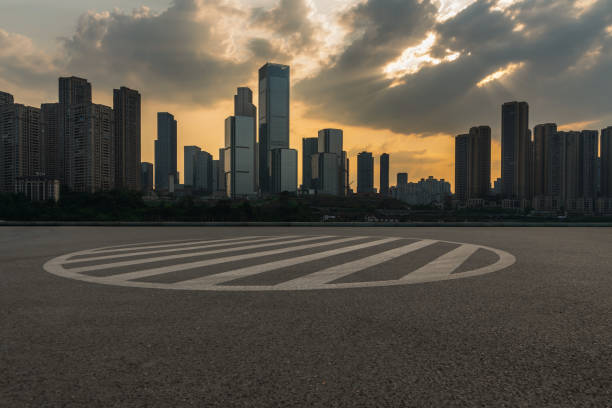 istock empty asphalt ground and modern cityscape with beautiful sunrise. 1321614781