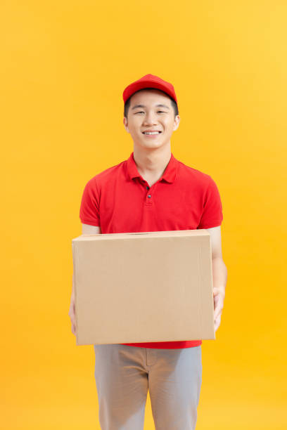 istock delivery man with box isolated over color 1321626022