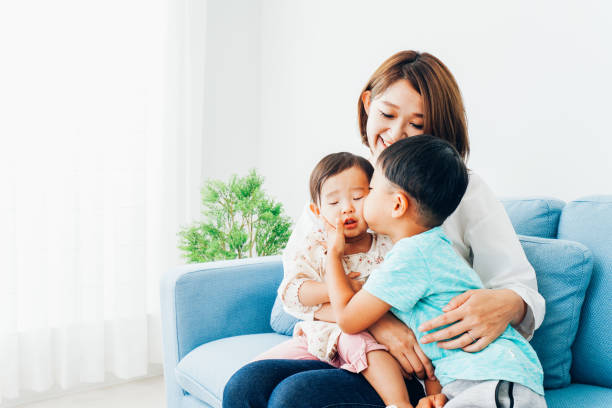 A young housewife playing with her children at home A young housewife playing with her children at home korean baby stock pictures, royalty-free photos & images