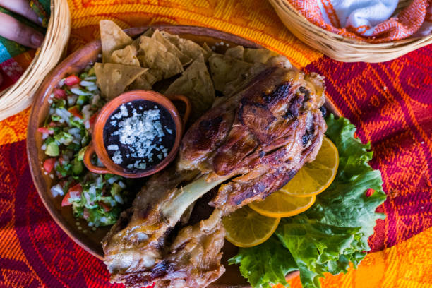 istock Roasted meat with vegetables and refried beans on colorful tablecloth 1321632085