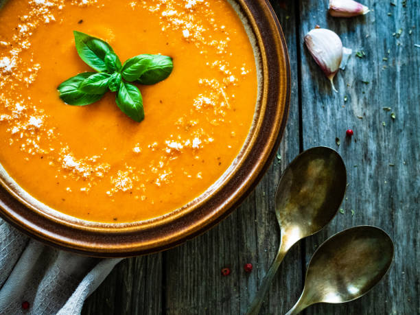 istock Cream tomato soup with parmesan on wooden table 1321639307