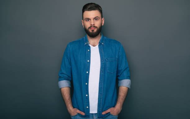 istock Confident serious hipster modern bearded man is posing and looking right on the camera. 1321640962