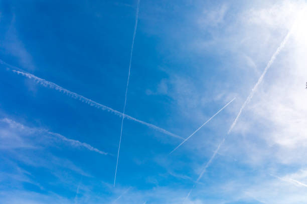 istock Bright blue sky with the many inversion tracks from aircrafts 1321641744