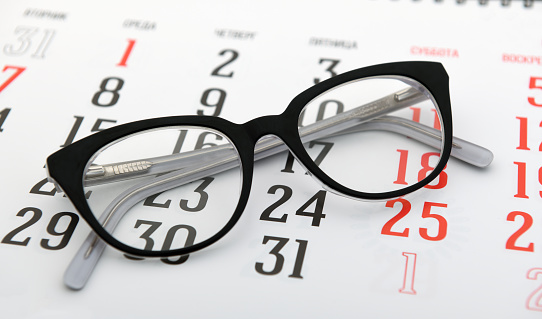 Glasses are on the calendar.Tax day, calendar, glasses.
