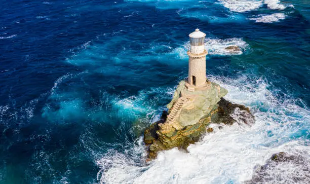 Photo of The beautiful Lighthouse Tourlitis of Chora at night. Andros island, Cyclades, Greece