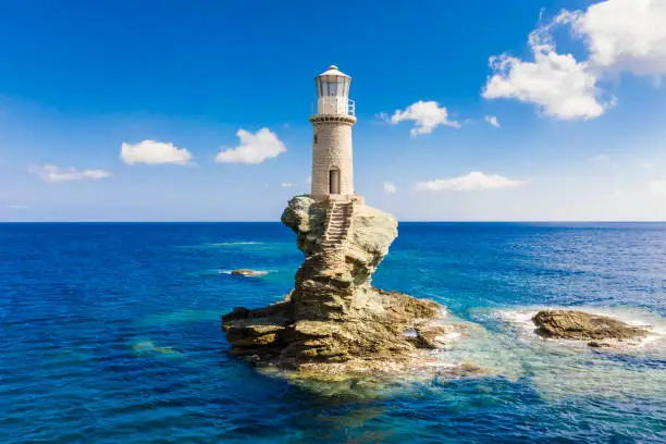 Photo of The beautiful Lighthouse Tourlitis of Chora at night. Andros island, Cyclades, Greece