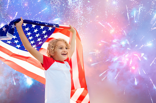 American family celebrating 4th of July. People watching Independence Day fireworks holding US flag. Proud USA kids cheer and celebrate. Child with America symbol. National holiday party.