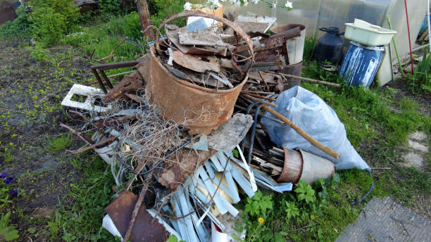 istock Garbage pile with iron and plastic on the grass. Heap with old rusty iron, tanks, containers, springs. 1321649436
