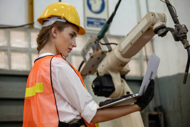 istock Engineer and worker control and check robot working in factory. The worker is controlling the robot to work in the factory. 1321649731