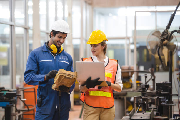 istock Engineer and worker control and check robot working in factory. The worker is controlling the robot to work in the factory. 1321649991