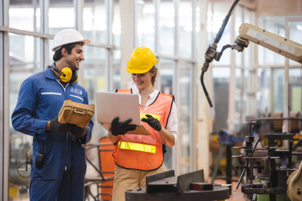 istock Engineer and worker control and check robot working in factory. The worker is controlling the robot to work in the factory. 1321650029