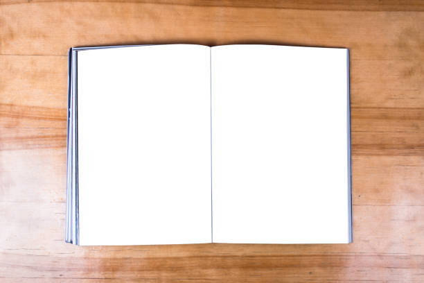 istock Aged opened book with white blank pages for mockup lying on wooden table 1321650790