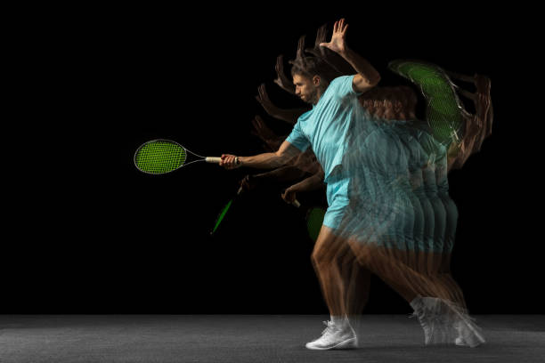 istock Stroboscope effect. One man, professional tennis player isolated on black background in mixed neon light. 1321651100