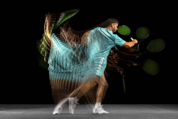 istock One man, professional tennis player isolated on black background in mixed neon light. Stroboscope 1321651114