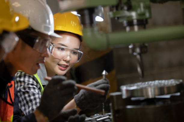 istock Asian Group industrial manager man demonstration and training mechanic worker woman  operating industrial lathe machine. Industry and engineering people technology concept . 1321652707