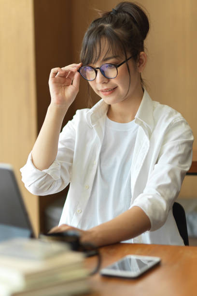 istock Female student with eyeglasses preparing for upcoming exam with digital tablet in cafe 1321652915