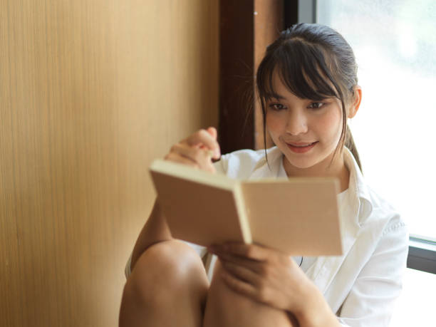 istock Female student reading to prepare for upcoming exam with her lecture notebook 1321653061