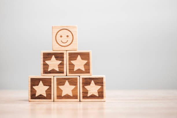 istock emotion face and Star symbol blocks on table background. Service rating, ranking, customer review, satisfaction, evaluation and feedback concept 1321653218
