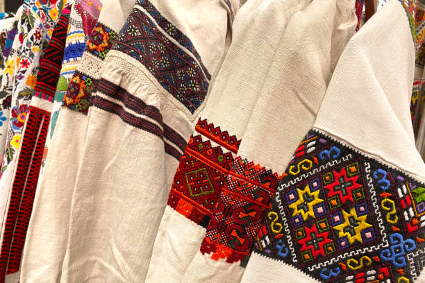 istock Different Ukrainian vintage clothes - traditional embroidered shirts, vyshyvanka. Secondhand goods on flea market, thrift shopping concept 1321654435