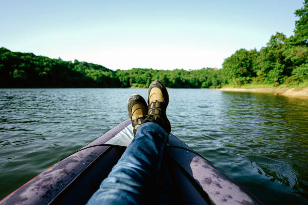 istock Man with legs stretched out in canoe 1321654770