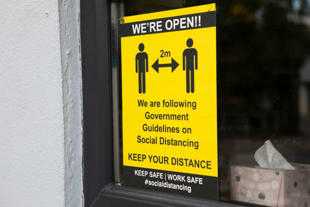 istock Social distancing sign in a store window 1321655150