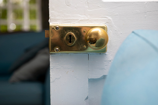 A woman's hand on a black metal door handle. Fire safety Door sign.