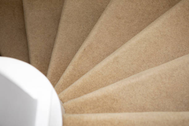 istock Looking down a spiral staircase, with beige coloured carpet 1321655725