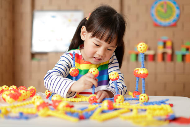 istock Cute Girl Playing With Toy At Home 1321659111