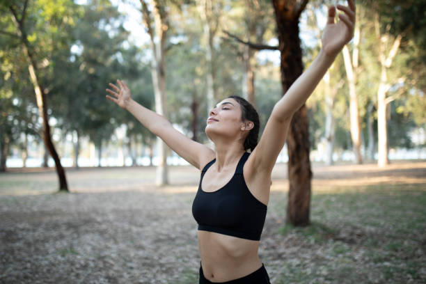 istock woman exercising at green park 1321660689