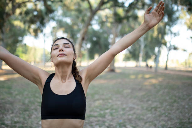 istock woman exercising at green park 1321660923