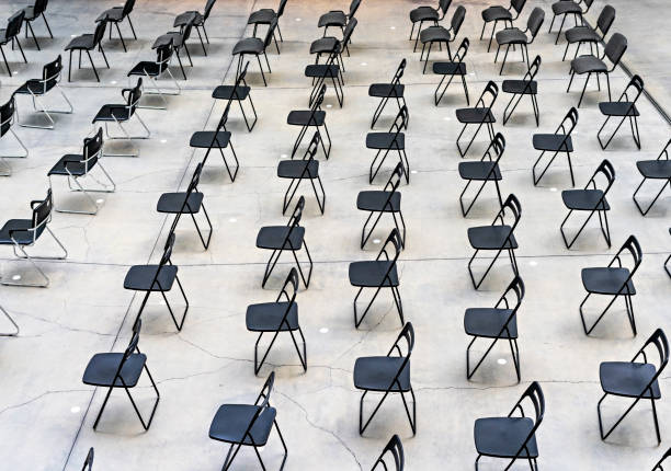 istock Many black chairs standing indoors at the same distance before the event 1321661760