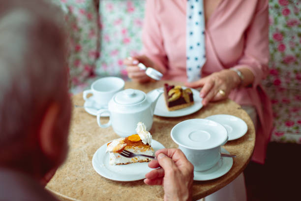 A scene at the local cafeteria, depicting a husband and wife celebrating their anniversary, just the two of them, enjoying the house specialties and a good conversation.