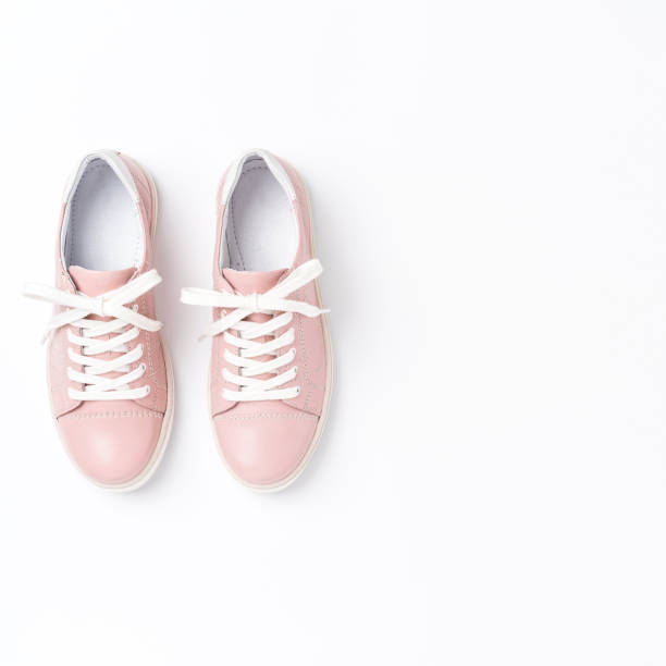 istock Pink sneakers on white background 1321662489