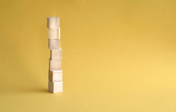 istock 7 letter blank and wood block stacked up, yellow background. Copy space. 1321664177
