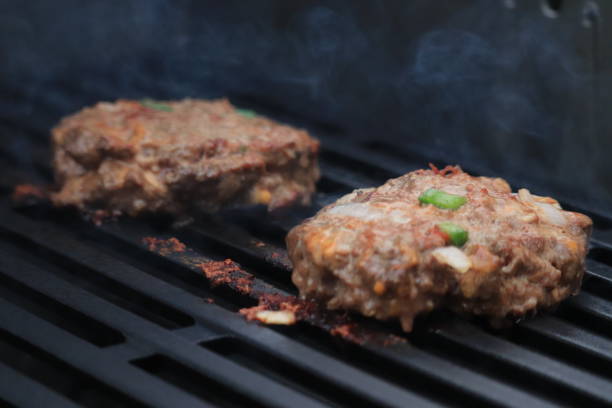 istock Burgers on the grill 1321664453