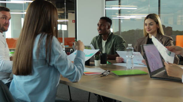 istock Multiethnic group of people in modern office. Creative business team working on project together, laughing and smiling. 1321664617