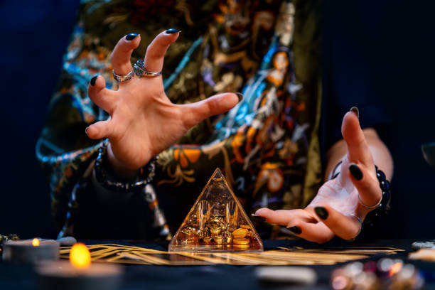 istock A witch is guessing and conjuring over a glass pyramid. Hands close-up. The concept of divination and astology 1321670645