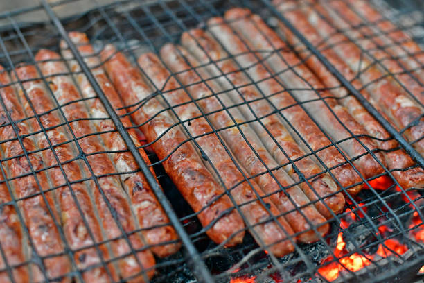 Large bratwurst sausage grill, typical fast food on the street at a German traveling fun fair and Christmas market, selected focus, narrow depth of field
