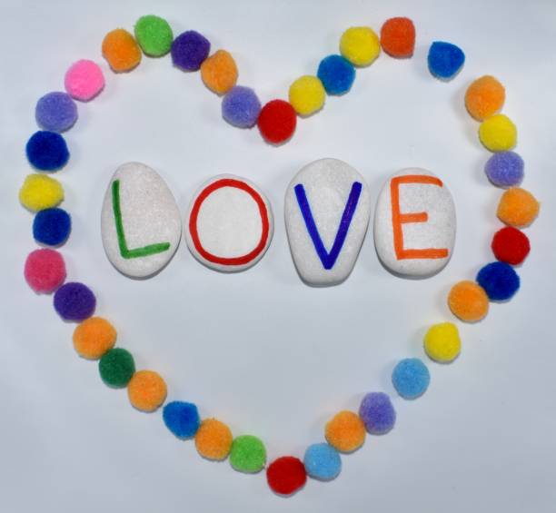 istock Love written on white stones in a colourful heart 1321672432