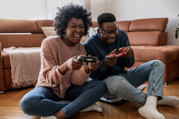 istock Couple at home having fun and playing video games 1321674020